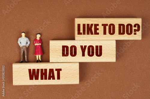 Wallpaper Mural On a brown surface, wooden blocks with the inscription - WHAT DO YOU LIKE TO DO, there are figures of people. Torontodigital.ca