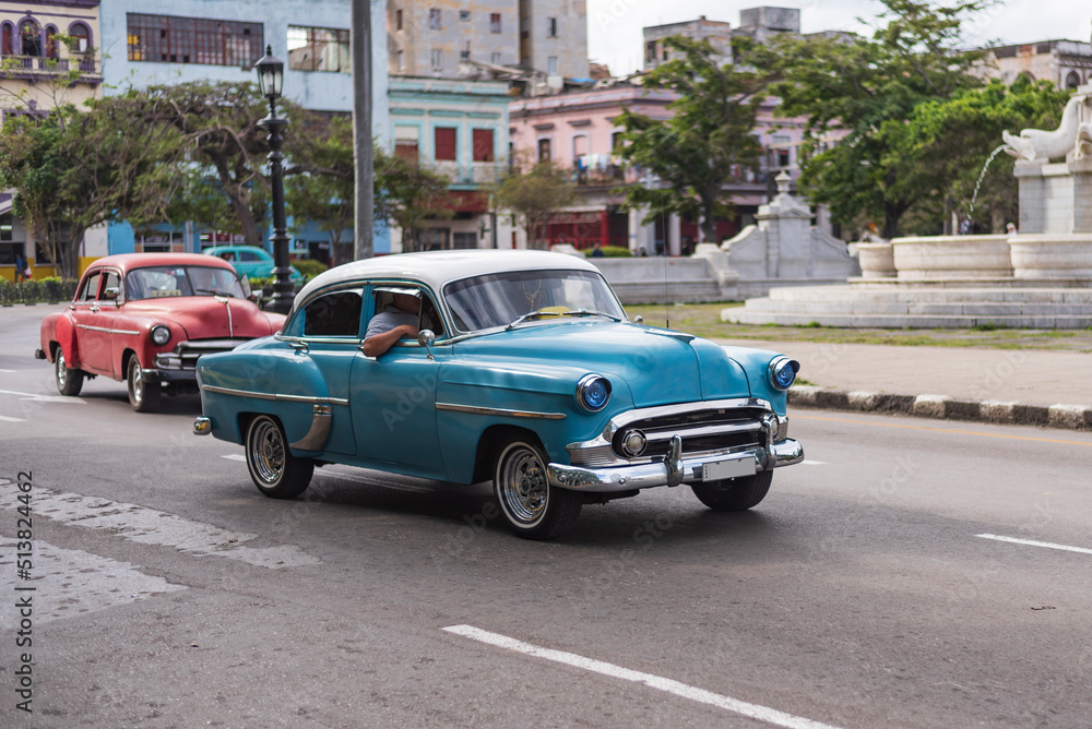 baby blue and white classic car on the street of havana cuba