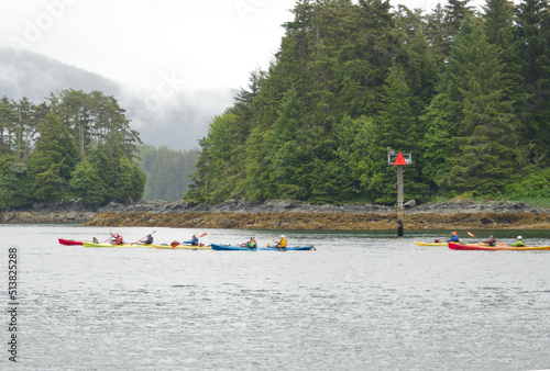 Photography A group of unidentifiable people Kayaking near Sitka Alaska on a misty cloudy summer day