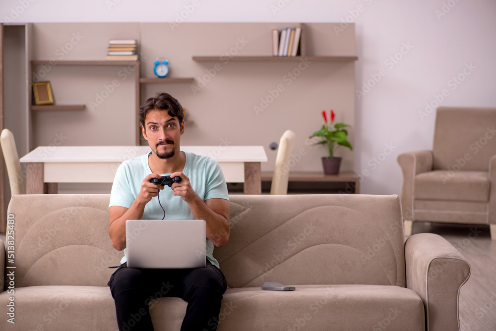 Young man playing joystick games at home Young man playing joystick games at home