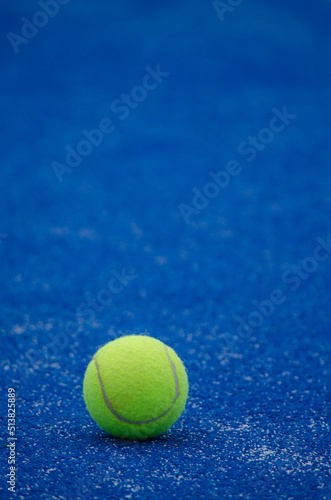 selective focus, one ball on a blue paddle tennis court