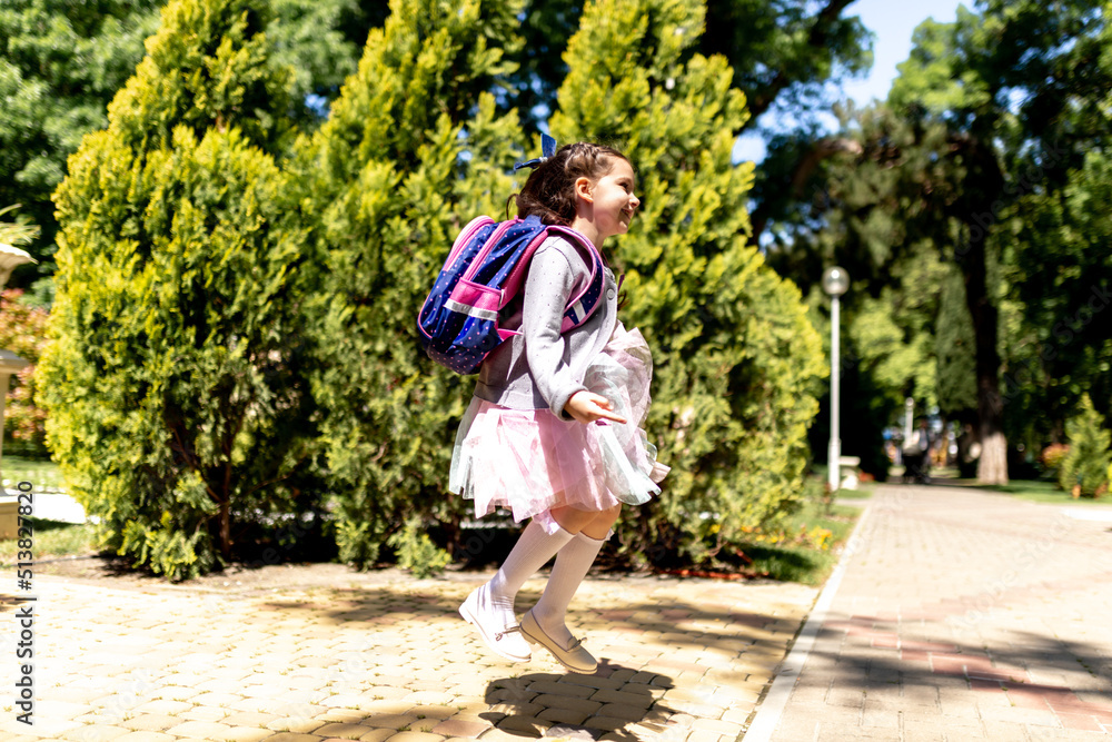 Back to school. Cute child girl with backpack running and going to school with fun