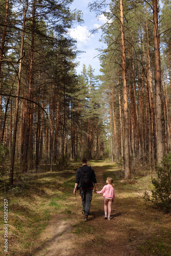 Young dad and daughter walk