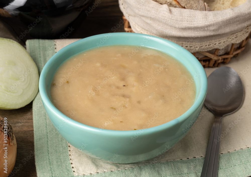 Onion soup in a bowl with bread and wine Onion soup in a bowl with bread and wine