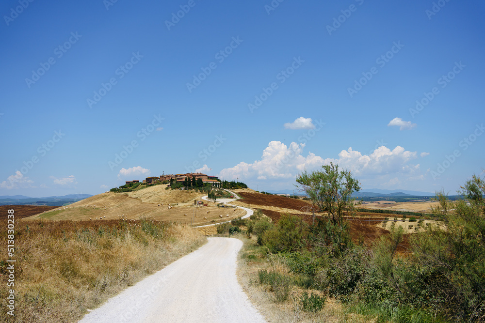 Tuscany landscape with road to house 