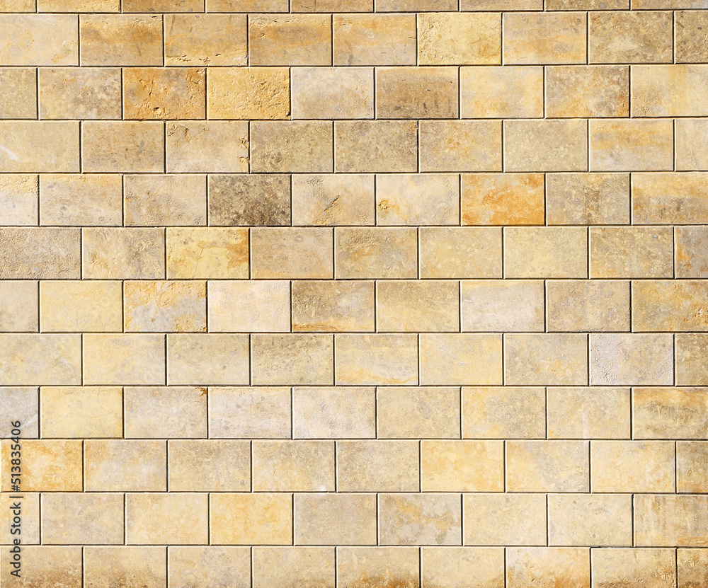 Naklejka premium A wall made of natural stones as a background