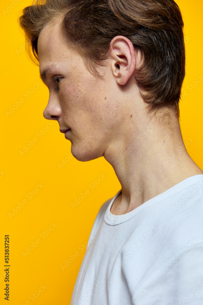 portrait of a guy with freckles standing sideways to the camera portrait of a guy with freckles standing sideways to the camera