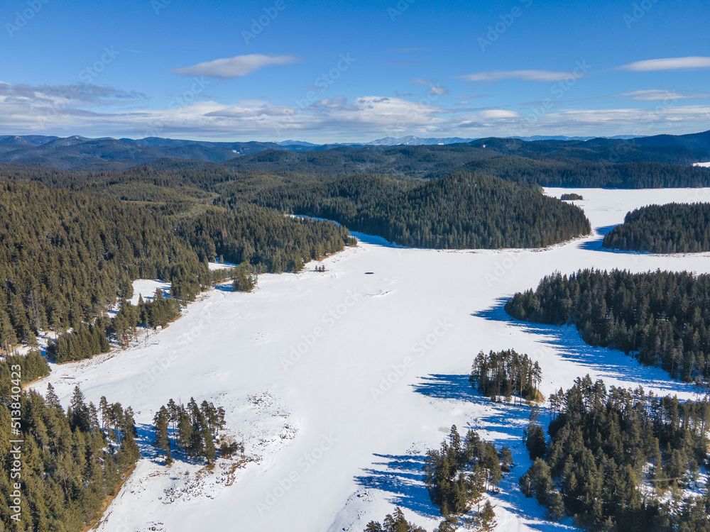 Aerial winter view of Shiroka polyana Reservoir covered with ice,  Bulgaria