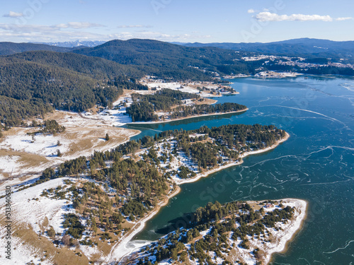 Aerial winter view of Dospat Reservoir covered with ice, Bulgaria