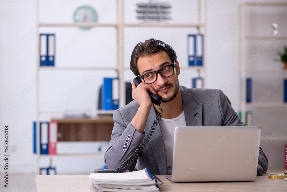 Young male employee working in the office Young male employee working in the office
