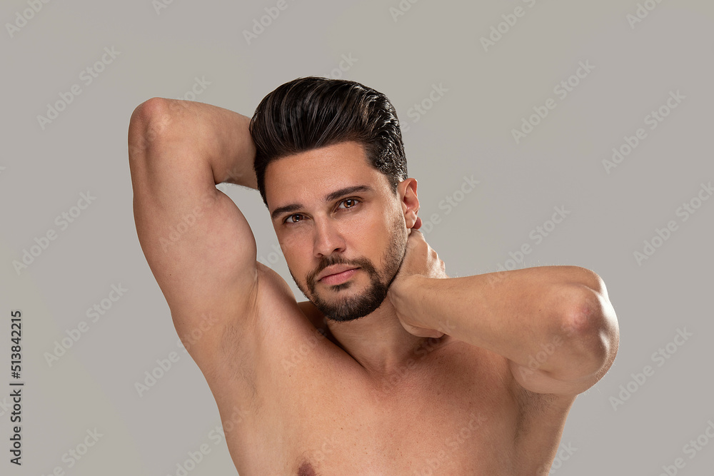 Fototapeta premium Studio beauty portrait of a handsome, sexy man with beard looking at the camera.