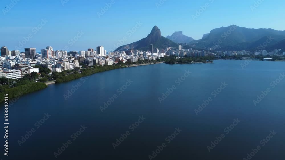 Aerial view of Rodrigo de Freitas Lagoon, south zone of Rio de Janeiro, Brazil. In the background, the beaches of Ipanema and Leblon and Morro Dois Irmãos. Sunny day. Buildings around. Drone take. Aerial view of Rodrigo de Freitas Lagoon, south zone of Rio de Janeiro, Brazil. In the background, the beaches of Ipanema and Leblon and Morro Dois Irmãos. Sunny day. Buildings around. Drone take.
