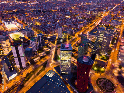 Photography Panoramic aerial view of illuminated business district of Barcelona with modern