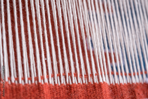 Close up, Detail of loom for weaving traditional handmade carpets, rugs.  Weaving and manufacturing of Turkish style homemade carpets. Selective focus.
