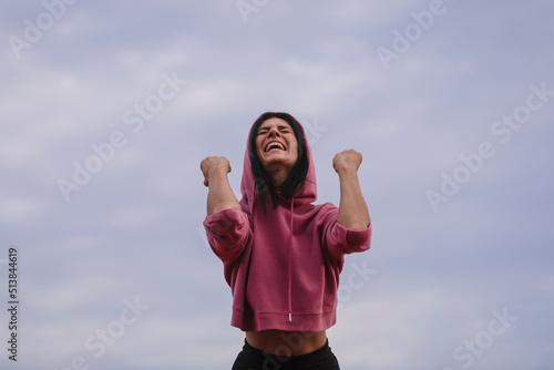 happy person with arms raised. Yes woman. Happy day. Lifestyle. Photo. Sky background. Smile. 