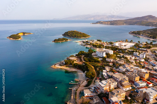 Aerial view of coastal area of city of Ksamil in bay of Mediterranean Sea in spring, Albania.. photo
