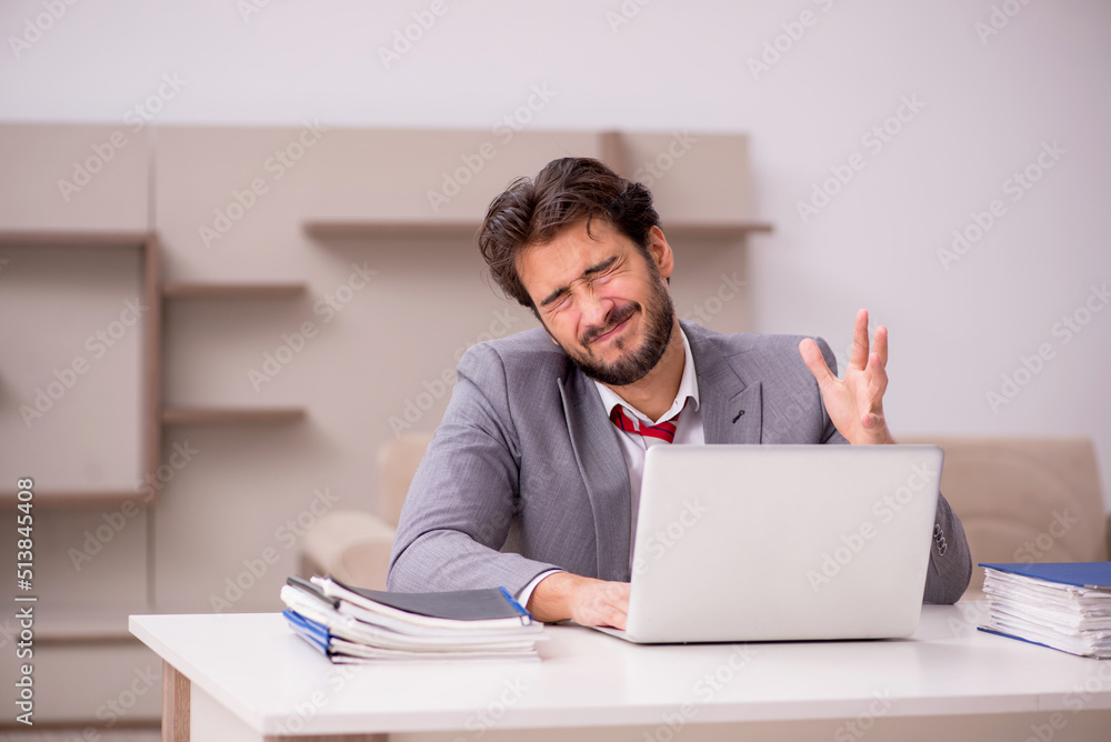 Young male employee working from home during pandemic Young male employee working from home during pandemic
