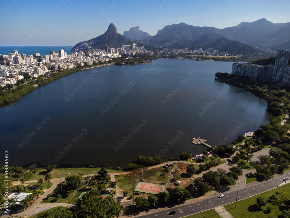 Aerial view of Rodrigo de Freitas Lagoon, south zone of Rio de Janeiro, Brazil. In the background, the beaches of Ipanema and Leblon and Morro Dois Irmãos. Sunny day. Buildings around. Drone photo