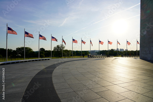 Anerican flags and Whashington monument against sky at sunset