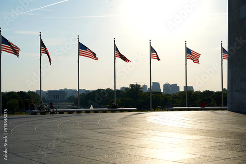 Anerican flags and Whashington monument against sky at sunset photo