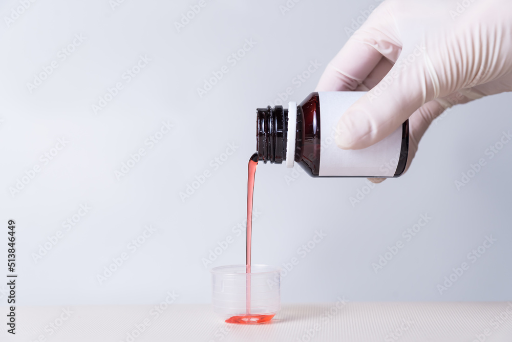 doctor serving syrup, lung problems, space for copy, health and wellness concept doctor serving syrup, lung problems, space for copy, health and wellness concept