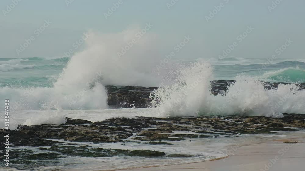 Large ocean waves crash against the stones. Slow motion water splashes. Beautiful seascape with crashing waves on rocks. Scenic view of the sea coast in summer sunny day. Travel destinations, Portugal Large ocean waves crash against the stones. Slow motion water splashes. Beautiful seascape with crashing waves on rocks. Scenic view of the sea coast in summer sunny day. Travel destinations, Portugal
