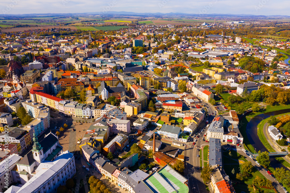 Panoramic aerial view of autumn scape of Czech city of Opava on bank of small river on sunny day, Moravian-Silesian Region