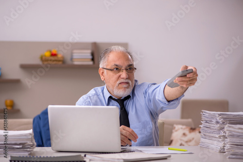 Old male boss working from home during pandemic