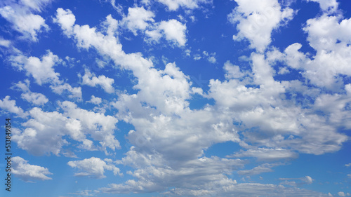 Beautiful puffy clouds under a sunny blue sky.