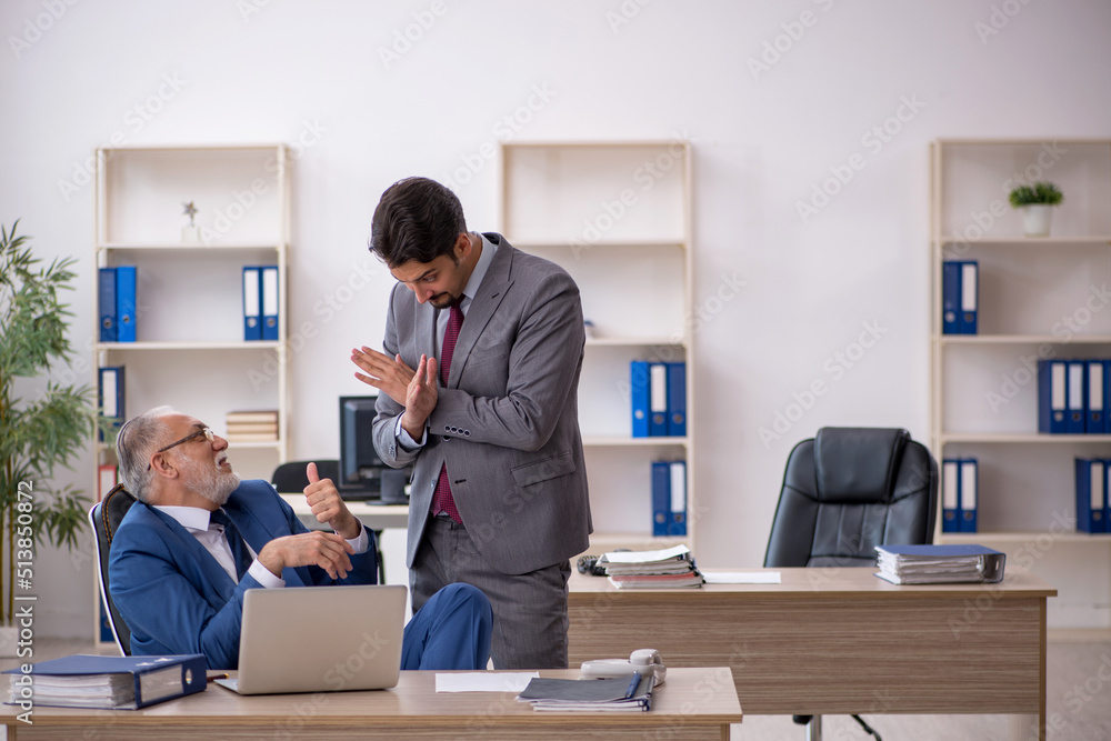 Two male colleagues working in the office Two male colleagues working in the office