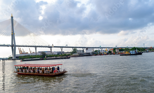 Transport boats crossing the Chao Phraya River near Bhumibol Bridge Bangkok, Thailand