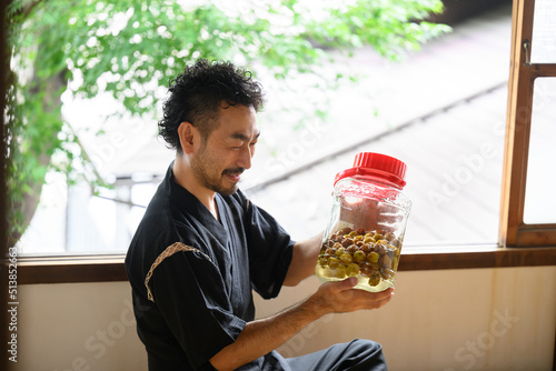 Japanese man making Umeshu (plum wine) photo