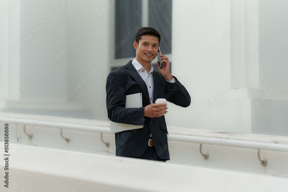 Portrait of Asian Business man talking and dealing with customer by cell phone. Account and Finance concept. Portrait of Asian Business man talking and dealing with customer by cell phone. Account and Finance concept.