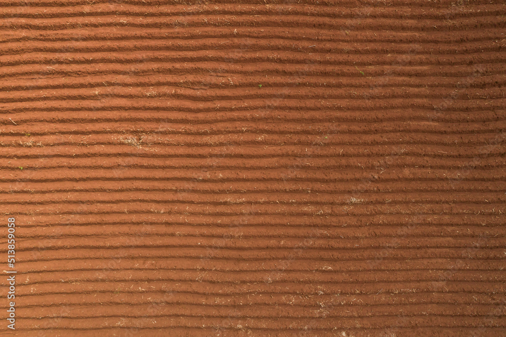 Aerial view ; Rows of soil before planting.Sugar cane farm pattern in a plowed field prepared for background Aerial view ; Rows of soil before planting.Sugar cane farm pattern in a plowed field prepared for background