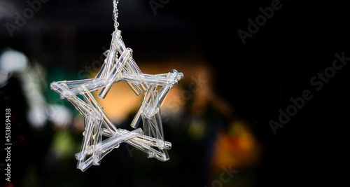 star shape light decoration, on black background, made from many short glass tubes, free space on rigth.