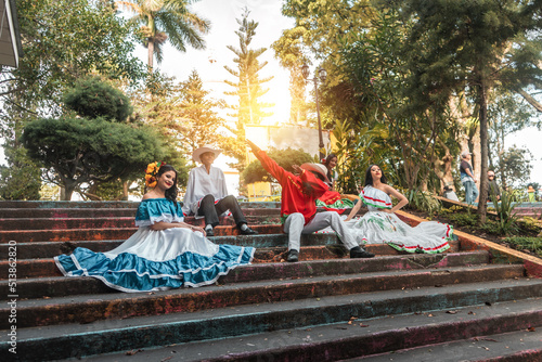 Fototapeta Teenagers from Latin America with traditional costumes doing a dab on the steps