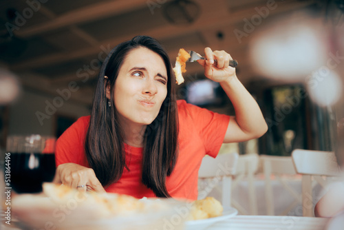 Exigent Woman Over Analyzing Food Course in a Restaurant - Worried customer suffering from orthorexia worried about cholesterol photo