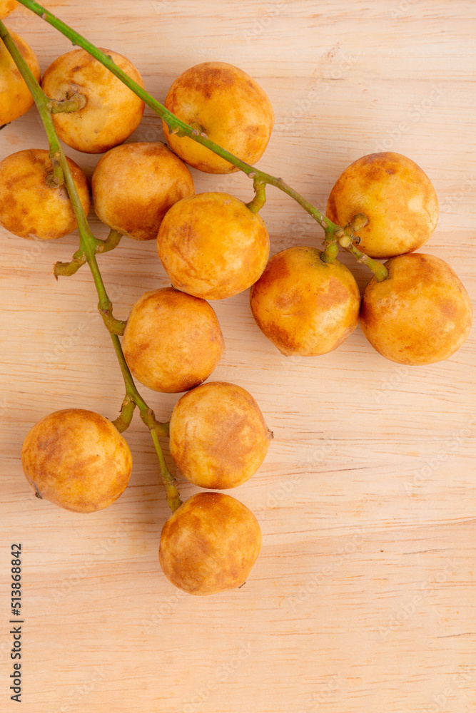 Thai fruit. Fresh ripe mafai with sweet and sour on wood table.Close-up Thai fruit. Fresh ripe mafai with sweet and sour on wood table.Close-up