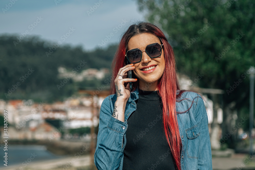 pretty redhead girl with mobile phone in the street. pretty redhead girl with mobile phone in the street.