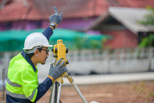 фотографія Male civil engineer surveying with theodolite apparatus Before construction on t