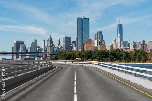 Empty urban asphalt road exterior with city buildings background. New modern highway concrete construction. Concept of way to success. Transportation logistic industry fast delivery. New York. USA.