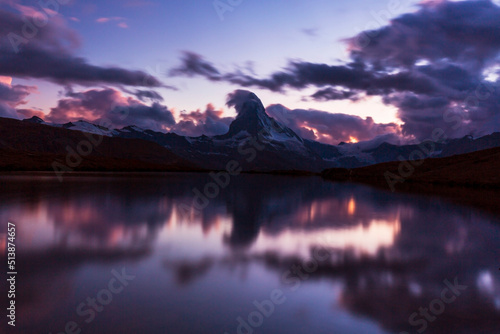 Beautiful sunset colors and cloudscape in the Swiss Alps in summer, with Matterhorn reflection in a lake