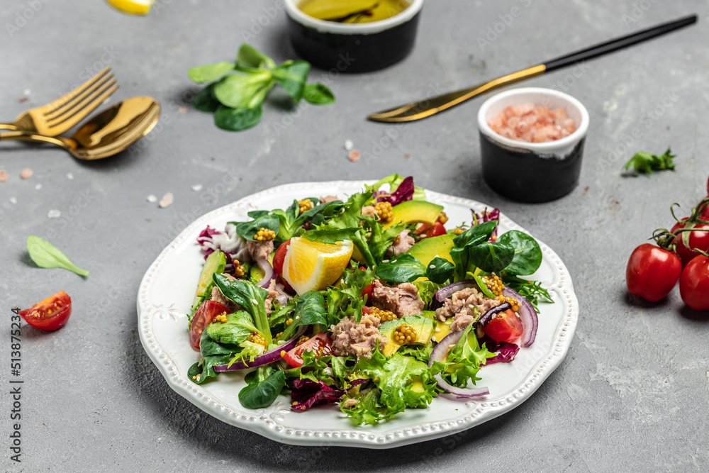 Tuna salad with lettuce, cherry tomatoes, avocado and red onions. Delicious breakfast or snack, Clean eating, dieting, vegan food concept. top view Tuna salad with lettuce, cherry tomatoes, avocado and red onions. Delicious breakfast or snack, Clean eating, dieting, vegan food concept. top view