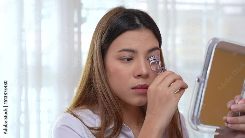 Beautiful woman using eyelash curlers. Make up with cosmetics for beauty. Beautiful woman using eyelash curlers. Make up with cosmetics for beauty.