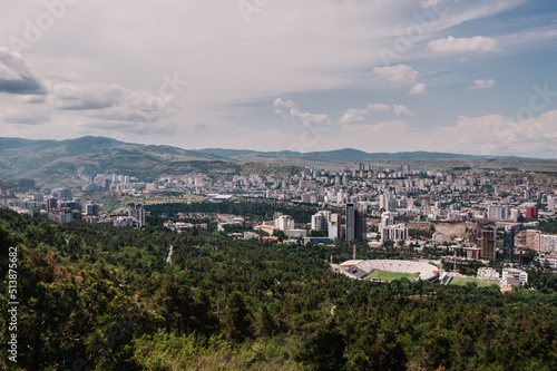 View of the city of Tbilisi in the capital of Georgia. All main landmarks on one shot: church, new and old houses, tower, city, town, mountains, park, stadium and streets.