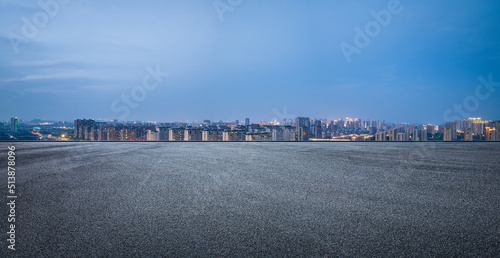 Asphalt road and modern city skyline with building scenery at night. high angle view.