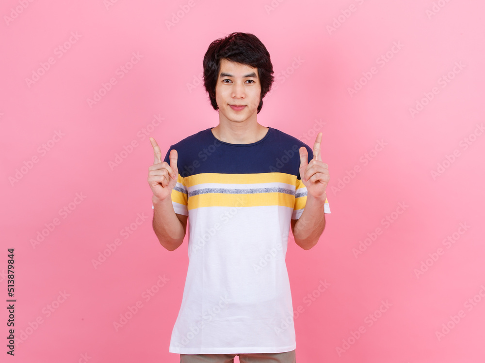 Portrait studio shot of Asian young handsome urban teenager fashion male model in street style outfit t shirt sport beige pants standing posing look at camera on pink background. Portrait studio shot of Asian young handsome urban teenager fashion male model in street style outfit t shirt sport beige pants standing posing look at camera on pink background.