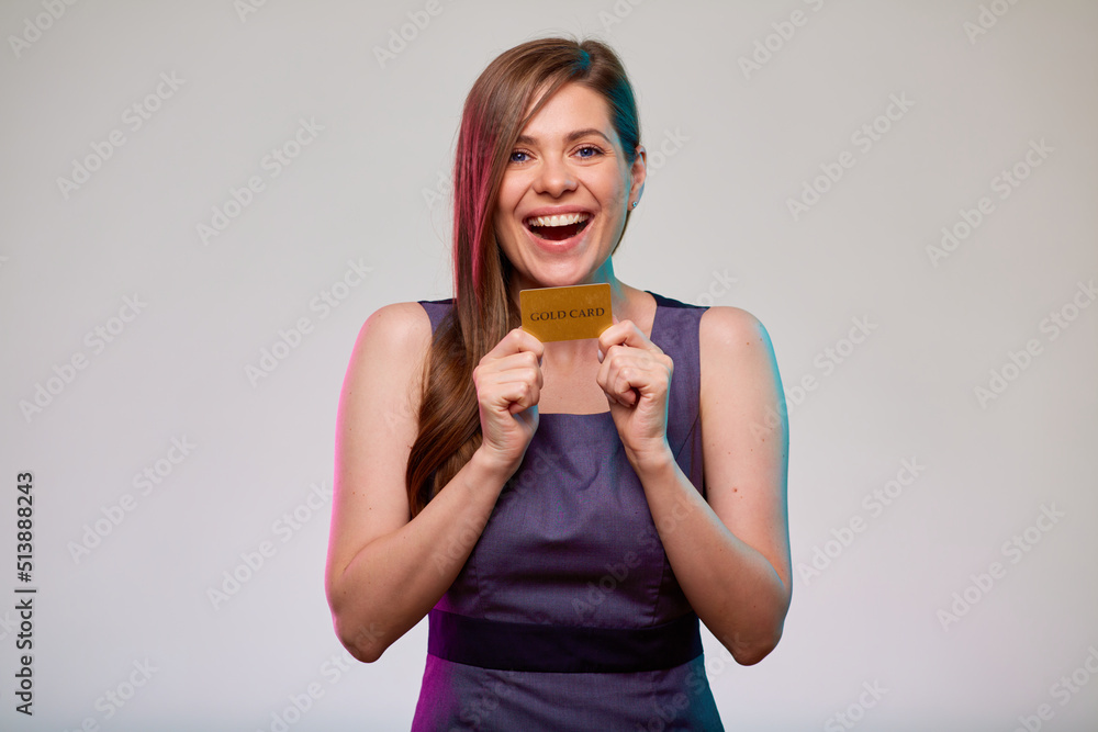 Smiling happy business woman holds gold credit card, isolated portrait of bank employee. Smiling happy business woman holds gold credit card, isolated portrait of bank employee.
