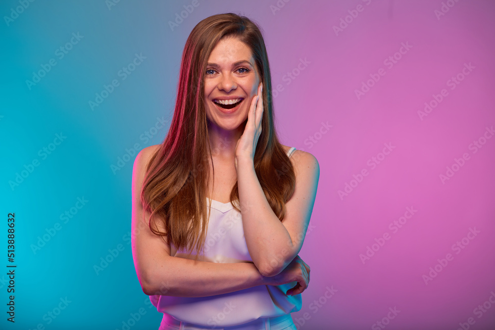 Happy smiling woman with one hand up, portrait with neon lights colors effect. Female model isolated on neon background Happy smiling woman with one hand up, portrait with neon lights colors effect. Female model isolated on neon background