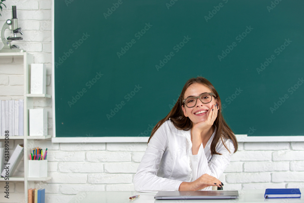 Female student on lesson lecture in classroom at high school or college. Happy school girl. Female student on lesson lecture in classroom at high school or college. Happy school girl.